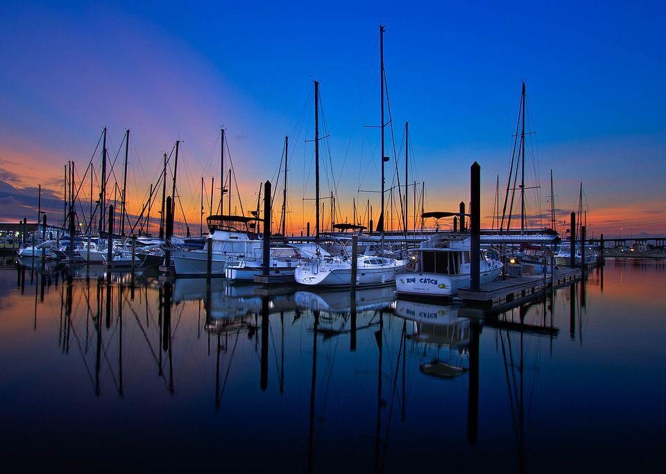 Sailboats docked in a Kemah-area marina at blue hour