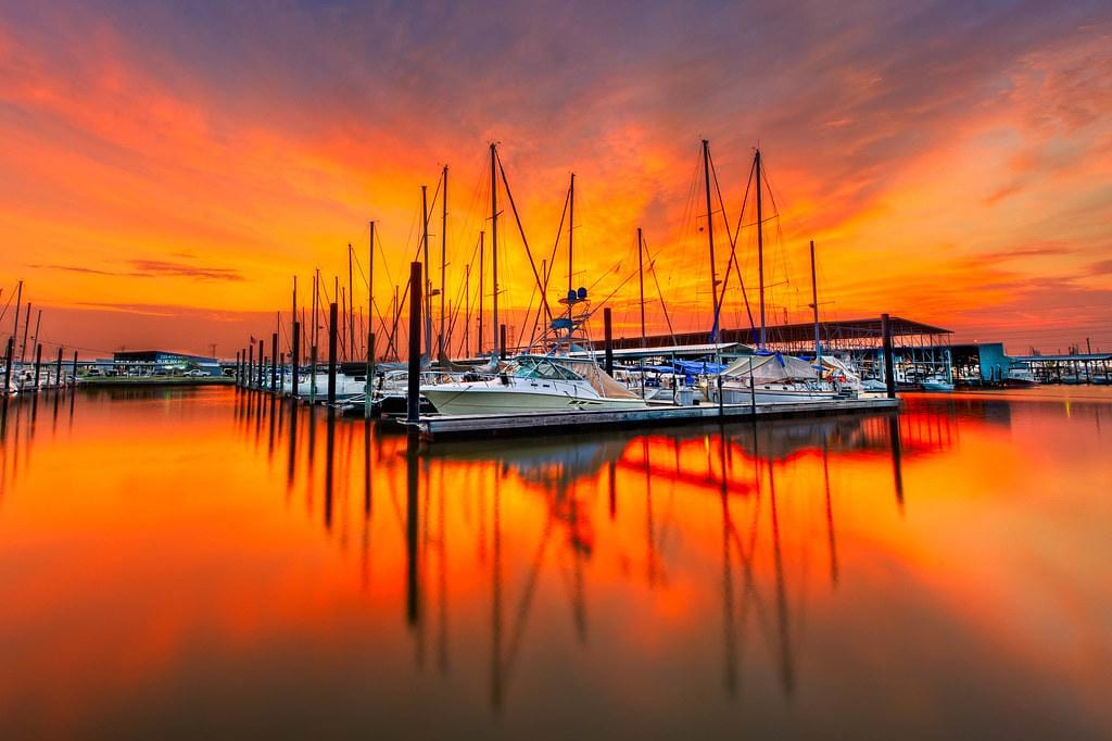 Sailboats docked in a Seabrook marina at dusk