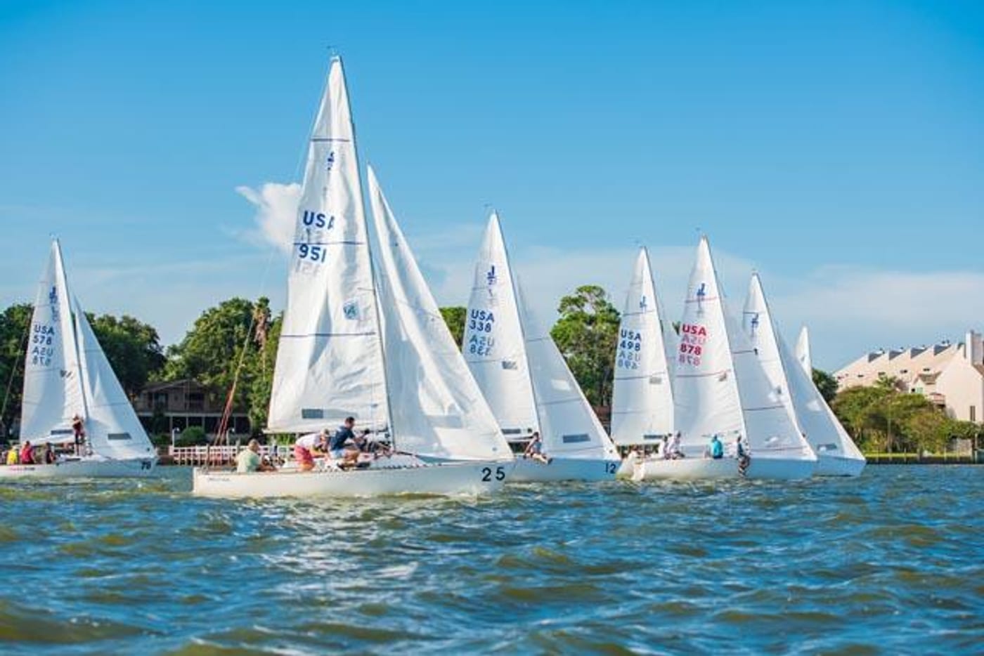 Sailboats racing on Clear Lake at sunset, a local Wednesday-night tradition